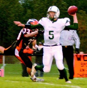 Cheboygan’s Dalton Jarvis (left) rushes after Alpena quarterback Tim Atkinson during the first quarter on Friday night.