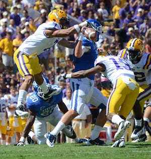 LSU cornerback Tyrann Mathieu goes airborne to force a fumble against Kentucky. Mathieu recorded a sack, forced fumble, fumble recovery and touchdown after the return on the play.