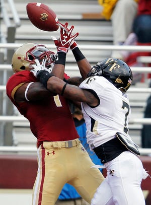 Wake Forest cornerback Merrill Noel (right) breaks up a pass to Boston College wide receiver Colin Larmond Jr. in the end zone in the fourth quarter of an NCAA college football game in Boston, Saturday. Wake Forest won 27-19.