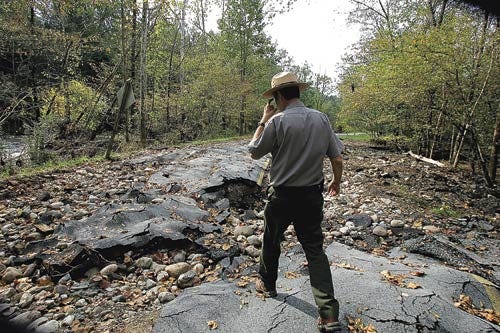 Photo by Tracy Klimek/New Jersey Herald - Management Assistant and Park Ranger Johnny Carawan shows a large section of Route 615 damaged during Hurricane Irene and continues to wash away with the rain, on Friday September 30, 2011.