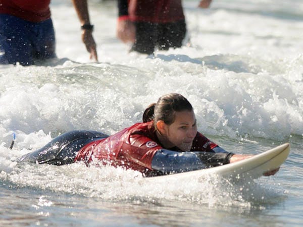 Sara Jenkins catches a wave during They Will Surf Again at Wrightsville Beach Saturday, October 1, 2011. The event is sponsored by Life Rolls On and involved approximately 100 volunteers with over 20 participants.