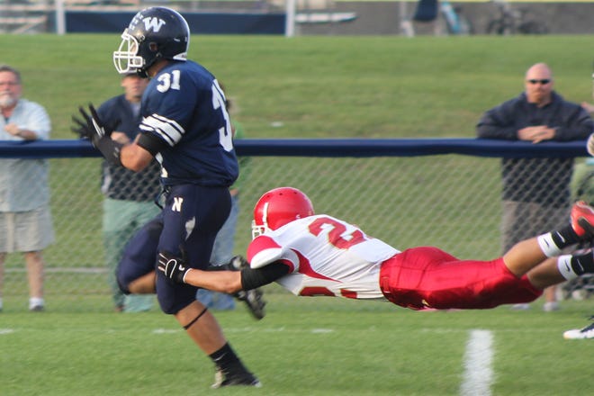 Bishop Connolly's Matt Amaral tries in vain to bring down Nantucket's Codie Perry during Saturday's game. Perry, a junior, scored on a 50-yard touchdown run in the Whalers' 14-0 victory.
