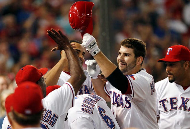 Texas' Mitch Moreland, second from right, celebrates his eighth-inning home run in the Rangers' 8-6 win against Tampa Bay in Game 2 of the American League Division Series on Saturday in Arlington.