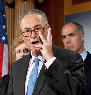 Sen. Charles Schumer, D-N.Y., center, flanked by Sen. Debbie Stabenow, D-Mich., left, and Sen. Robert Casey, D-Pa., gestures during a news conference on Capitol Hill in Washington on Thursday, Sept. 22, 2011, to discuss unfair currency manipulation.