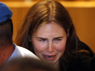Amanda Knox breaks in tears after hearing the verdict that
overturns her conviction and acquits her of murdering her British
roommate Meredith Kercher, at the Perugia court, central Italy,
Monday, Oct. 3, 2011. Italian appeals court threw out Amanda Knox's
murder conviction Monday and ordered the young American freed after
nearly four years in prison for the death of her British roommate
Knox collapsed in tears after the verdict overturning her 2009
conviction was read out. Her co-defendant, Italian Raffaele
Sollecito, also was cleared of killing 21-year-old Meredith Kercher
in 2007. (AP Photo/Pier Paolo Cito)