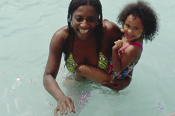 This Sunday, June 26, 2011 photo provided by Candella Matta shows Marie Joseph, foreground, holding family friend Dalianys Melendez, daughter of Candella Matta, in the public swimming pool at Lafayette Park in Fall River, Mass. The body of Marie Joseph, 36, was found floating in the pool two days later.