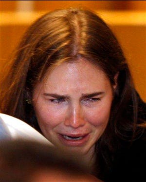 Amanda Knox breaks in tears after hearing the verdict that overturns her conviction and acquits her of murdering her British roommate Meredith Kercher, at the Perugia court, central Italy, Monday, Oct. 3, 2011.