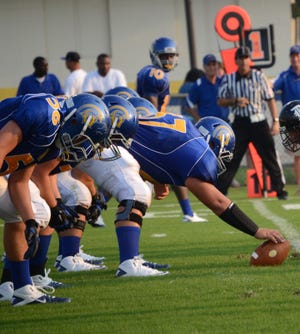 East Ascension center Jake Stoehr prepares for a snap along with the offensive line, including Eric Martin (No. 56) and wide receiver Deandrus Ennis (No. 10).