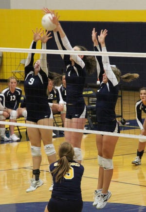 Sault High’s Megan Jean, Josie Werner and Jordan White, from left to right, put up a triple block against Gaylord Monday night.