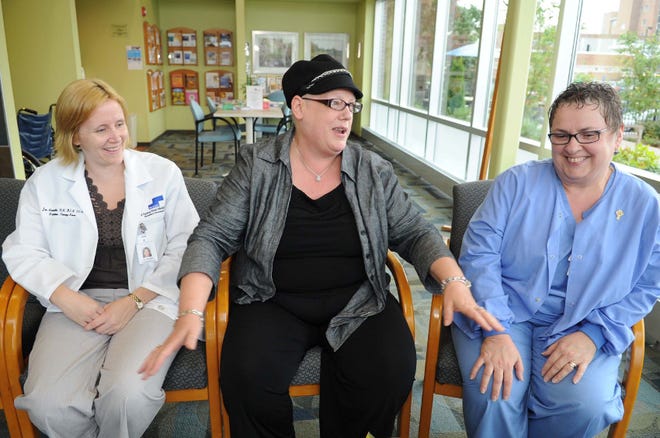 Laurie Smith, Brockton, center, and Jan Amorello, RN, left, Janine Couture, RN, right, after her last chemotherapy treatment at Good Samaritan Medical Center, on September 22, 2011. ()