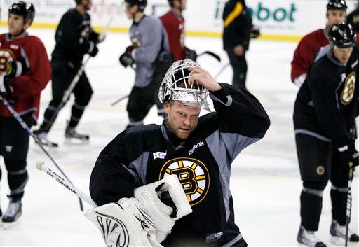 Bruins goaltender Tim Thomas takes his helmet off during a break in team practice at the TD Garden on Wednesday.