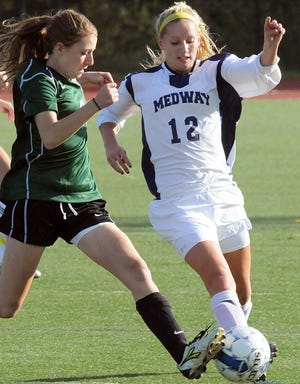 Medway's Leah Wadlinger (right) battles Westwood's Kaitlin Plecinoga for possession during the Mustangs' 2-1 win in Tri-Valley league action.