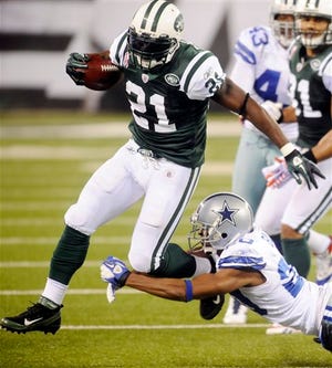 New York Jets running back LaDainian Tomlinson (21) avoids a tackle by Dallas Cowboys defensive back Alan Ball (20) during the second half of an NFL football game Sunday, Sept. 11, 2011, in East Rutherford, N.J. (AP Photo/Henny Ray Abrams)