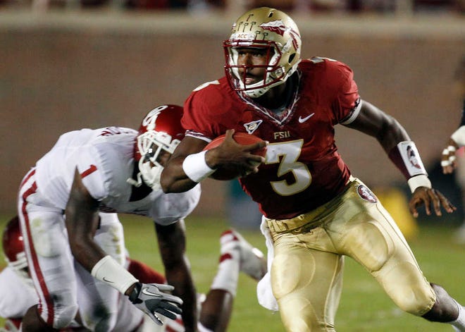 Florida State quarterback EJ Manuel (3) eludes Oklahoma defensive back Tony Jefferson (1) on a first quarter run during an NCAA college football game Saturday, Sept. 17, 2011, in Tallahassee, Fla. (AP Photo/Chris O'Meara)