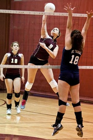 Cody Smith/Portsmouth Herald photo
Portsmouth's Sophie Meserve spikes the ball against St. Thomas' Gabrielle Ouellette (18) during Division II action Friday night in Portsmouth.