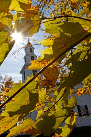 Foliage is seen in front of the Old Meeting House on Thursday, Oct. 6, 2011 in East Montpelier, Vt. Scientists don't quite know if global warming is changing the signs of fall like it already has with an earlier-arriving spring. They're turning their attention to fall foliage in hopes of determining whether climate change is leading to a later arrival of autumn's golden, orange and red hues. (AP Photo/Toby Talbot)