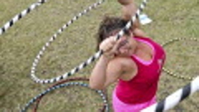 Casandra Tanenbaum, 31, of Hoops So Fly, brought out the hula hoops to help people get loose for The American Foundation for Suicide Prevention Florida Southeast Chapter Out of Darkness Walk to help prevent suicide held at the Meyer ampitheatre Sunday October 9, 2011.