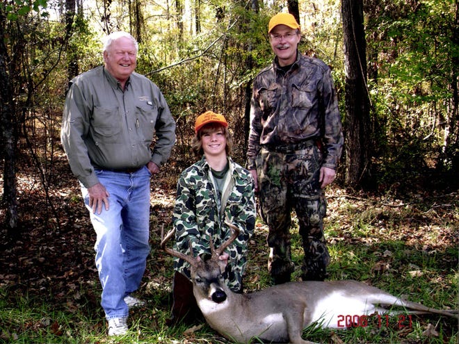 Corky Pugh, right, and George P. Mann, left, pose with Eddie Hackett and his first deer. Pugh calls this one of his “trophies” because he is most proud of the opportunites he’s given young people to hunt and fish. The deer was taken on Mann’s property. Pugh is retiring as director of the Division of Wildlife and Freshwater Fisheries.