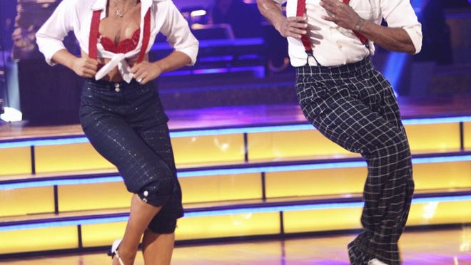 ORG XMIT: NYET176 In this image released by ABC, J.R. Martinez, right, and his partner Karina Smirnoff perform on the celebrity dance competition series, "Dancing with the Stars," Monday, Sept. 26, 2011 in Los Angeles. (AP Photo/ABC, Adam Taylor)