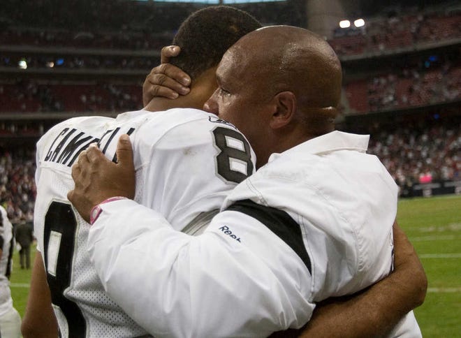 Oakland Raiders quarterback Jason Campbell (8) embraces head coach Hue Jackson after the Raiders defeated the Houston Texans 25-20 in an NFL football game Sunday, Oct. 9, 2011, in Houston. (AP Photo/Houston Chronicle, Brett Coomer) MANDATORY CREDIT
