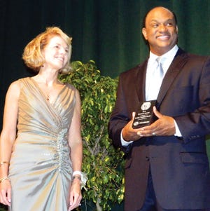 Dudley Hoskins Bostic, left, receives her award from talk show host Hallerin Hilton Hill.