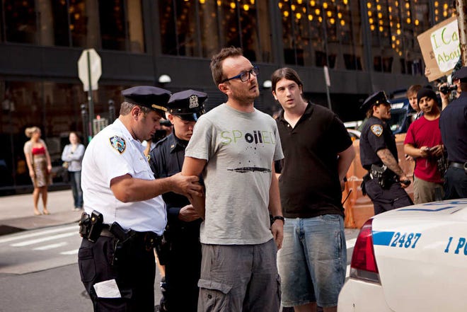 Laurentiu Garofeanu, right, is arrested by New York City police officers outside Zuccotti Park, Monday, Oct. 10, 2011, in New York. Garofeanu, who returned to the park after his arrest, said he and a second man were charged with disorderly conduct and released after approximately two hours. Garofeanu says he was taking photos of police officers when he was apprehended. (AP Photo/Andrew Burton)