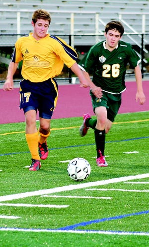 G-A’s Paul Herman rushes to the ball ahead of a James Buchanan player.