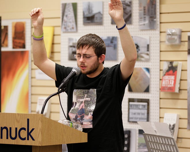 Callahan Crehan of Ashland sings for the crowd during last night's Photo Voice exhibit by the Wayside Youth and Family Support Network at Tatnuck Bookseller in Westborough.