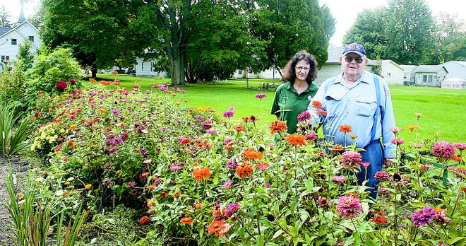 Art and Linda Walbridge stand behind their large flower garden in Quincy. The most prominent flowers in the garden are gladioli, and the couple have 72 varieties of the flower, down from over 100 several years ago.