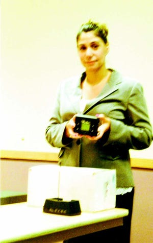 Amie Hutchins holding a new GPS electronic monitoring unit used with all sex offender probationers.