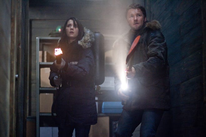 In this image released by Universal Pictures, Mary Elizabeth Winstead, left, and Joel Edgerton are shown in a scene from "The Thing."