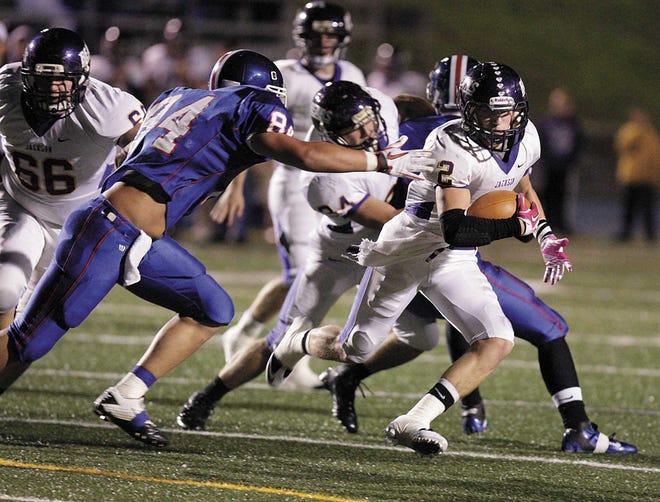 Jackson’s Jimmy Dehnke eludes the tackle of Lake’s Corey Paulino to score a touchdown in the first quarter Friday.