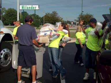 Alpine Bank employees unload cars at the East State Street location during the bank’s Shredding a World Record Community Shred Day.