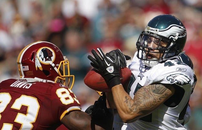 Eagles' safety Kurt Coleman intercepts a pass intended for
Redskins' tight end Fred Davis (83) during the first quarter
Sunday. Coleman had three interceptions in the 20-13 win.