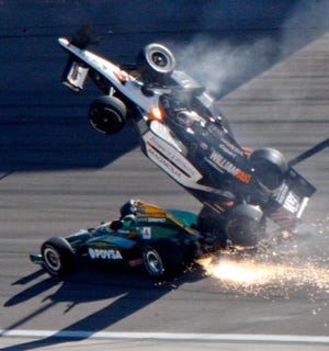 Dan Wheldon died yesterday after his car (top) went airborne during a wreck that involved 15 cars in Las Vegas yesterday.