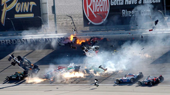 Drivers, including Dan Wheldon (77, in air at left), crash during a wreck that involved 15 cars during the IndyCar Series' auto race at Las Vegas Motor Speedway.