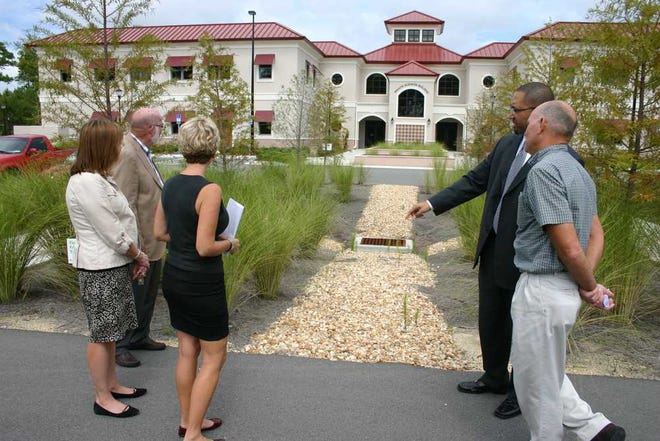 St. Johns River State College officials review the new bioswales on the St. Augustine campus. From left: SJR State executive vice president Melissa Miller, CRG architect Bob Goodwin, SJR State trustee Diane Leone, St. Augustine campus Provost Greg McLeod and facilities director Mike Canaday.