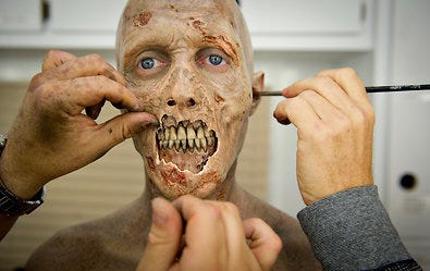 Kevin Galbraith goes through a two-hour makeup session outside Senoia, Ga., before filming a scene for the television series, "The Walking Dead."