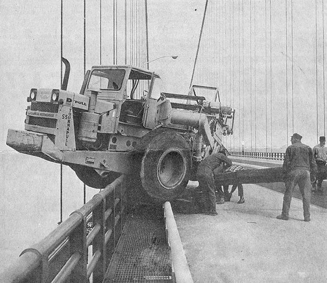Remarkably, no one was injured when the steering on this piece of heavy construction equipment went awry in this 1960s file photo, causing its big tires to nearly roll over the railing. Workmen were able to maneuver the vehicle back onto the roadway. Only a handful of traffic fatalities have occurred on the Mackinac Bridge since it opened to traffic in 1957.