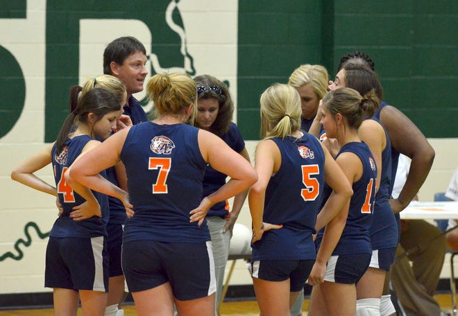 Ascension Christian coach Lisa Pellegrin meets with Lions volleyball players during a recent game.