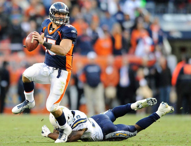 ADVANCE FOR WEEKEND EDITIONS, OCT. 15-16 - FILE - In this Oct. 9, 2011, file photo, Denver Broncos quarterback Tim Tebow (15) scrambles away from San Diego Chargers inside linebacker Donald Butler (56) in the fourth quarter during an NFL football game in Denver. Their Broncos are handing the offense over to Tebow. (AP Photo/Jack Dempsey, File)