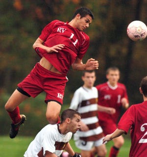 FILE PHOTO - Rancocas Valley's Dimitri Kustas heads the ball
over Delran's Mark Denny during a game last October.