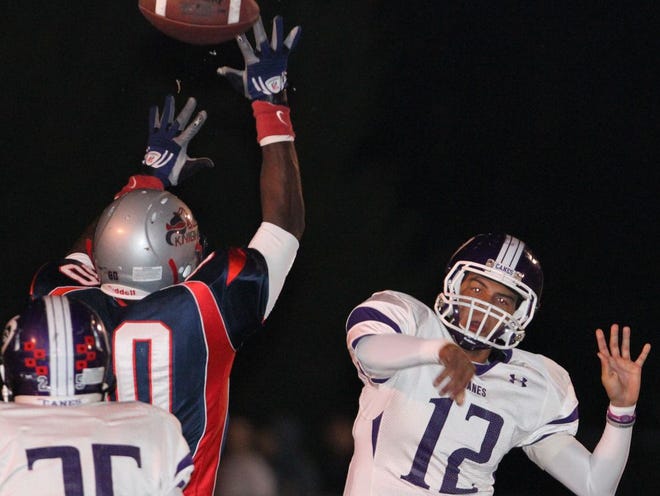 Vanguard's Najee Jamerson deflects a pass from Gainesville's quarterback Mark Cato during Friday night's game at Booster Stadium in Ocala on Oct. 21, 2011.