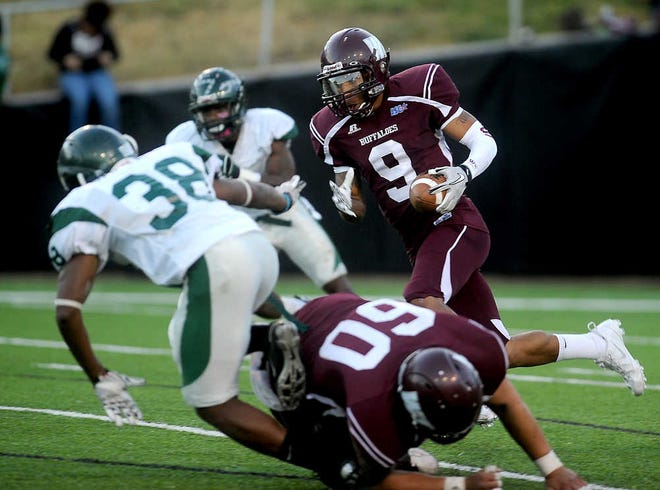 West Texas A&M's Brittan Golden (9) cuts through Eastern New Mexico defenders Saturday on his way to a 94-yard touchdown.
