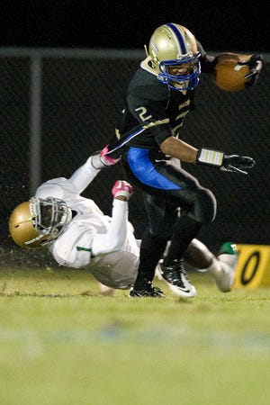 Craig Lyons (2) of Menendez is tackled by Denzell Hayden of Nease during Friday's game at Menendez. By Perry Knotts, Special to The Record.