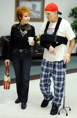 In this Oct. 3, 2011 file photo, Mark Lindquist, of Joplin, Mo., and his sister Linda Baldwin walk together prior to Lindquist's release from the Missouri Rehabilitation Center in Mount Vernon, Mo. Lindquist, injured in the Joplin tornado, ran up medical expenses that exceed $2.5 million, and the bills keep coming. He requires 11 prescriptions every day. In addition, he'll need more surgery. (AP Photo/The Joplin Globe, T. Rob Brown, File)