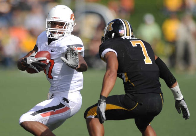 Oklahoma State wide receiver Tracy Moore, left, carries the ball as Missouri defensive back Randy Ponder defends during the fourth quarter of an NCAA college football game Saturday, Oct. 22, 2011, in Columbia, Mo. Oklahoma State won 45-24. (AP Photo/L.G. Patterson)