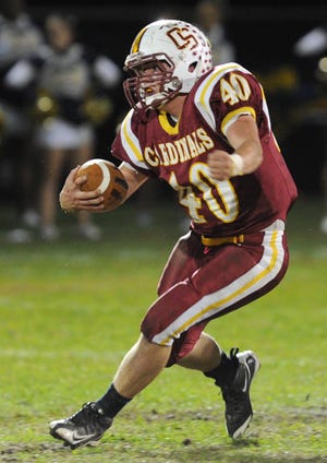 Cardinal Spellman's Pat Hinkley, carries the football on the ground in the second quarter during their game on October 22, 2011.