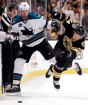 San Jose's Brad Winchester (left) collides with Bruins defenseman Dennis Seidenberg during last night's Sharks win at TD Garden.