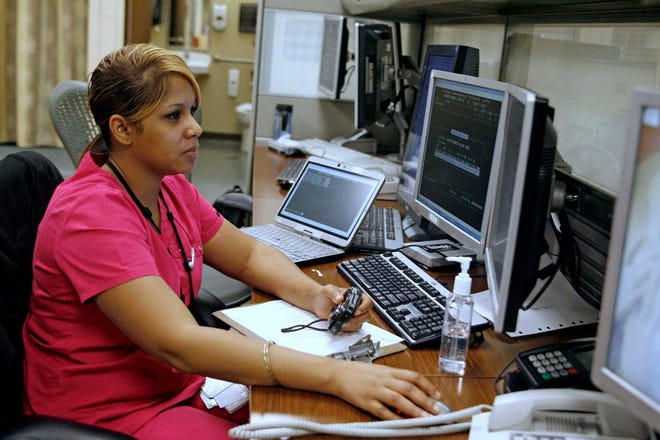 Charita Hart, an ER patient/finance representative, works in the Rockford Memorial Hospital Emergency Department Thursday, Oct. 20, 2011, in Rockford.